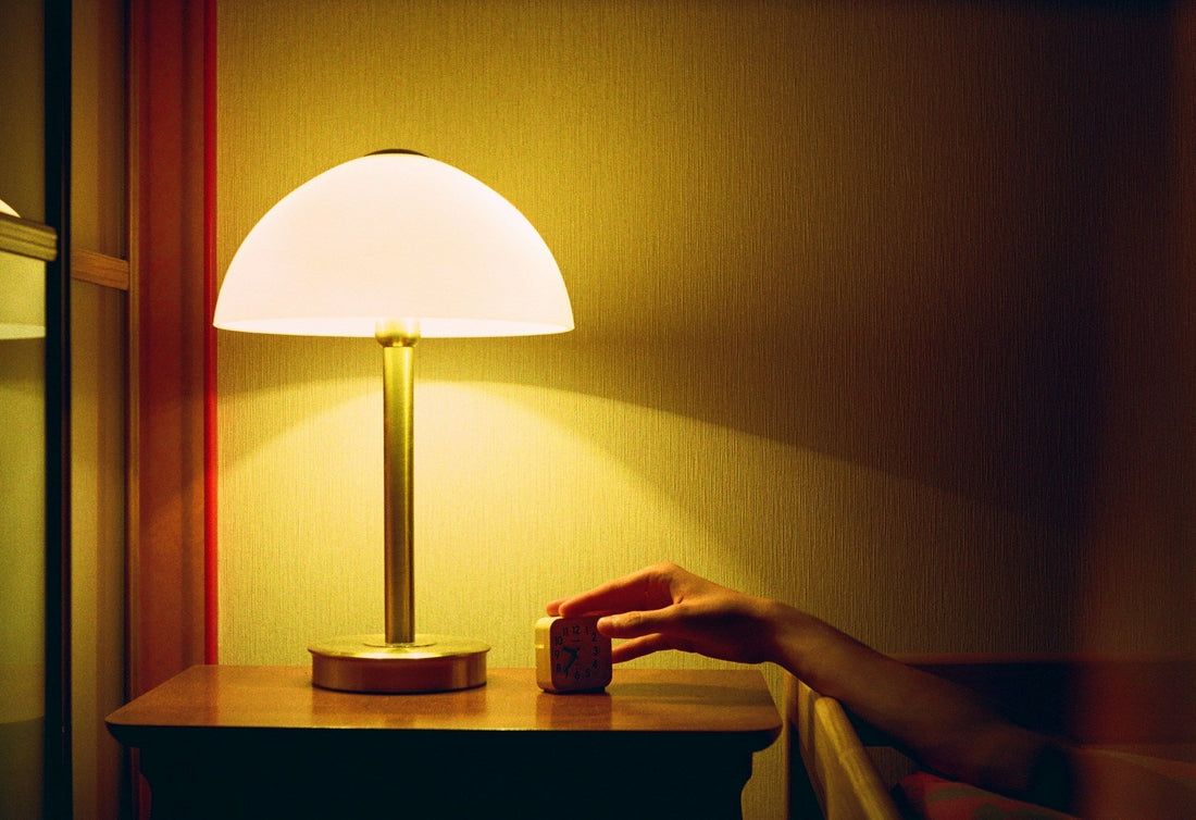 lamp on the bedstand beside bed