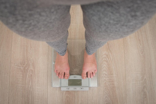 person standing on a weight scale